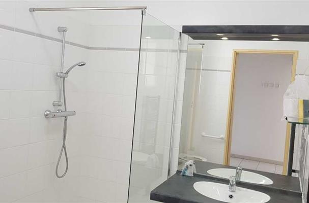 bathroom with shower and toilets